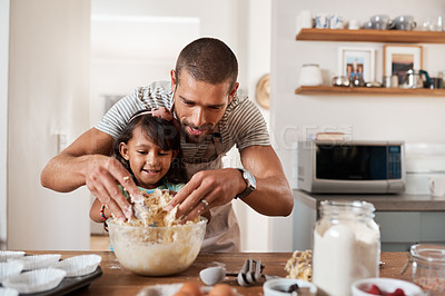 Buy stock photo Cropped shot of a young man baking at home with his young daughter