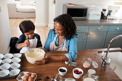 Buy stock photo Shot of a woman baking at home with her young son