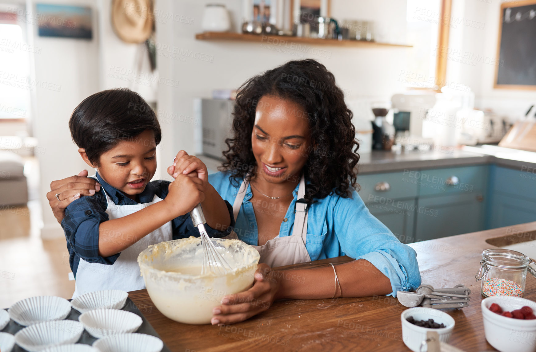 Buy stock photo Shot of a woman baking at home with her young son
