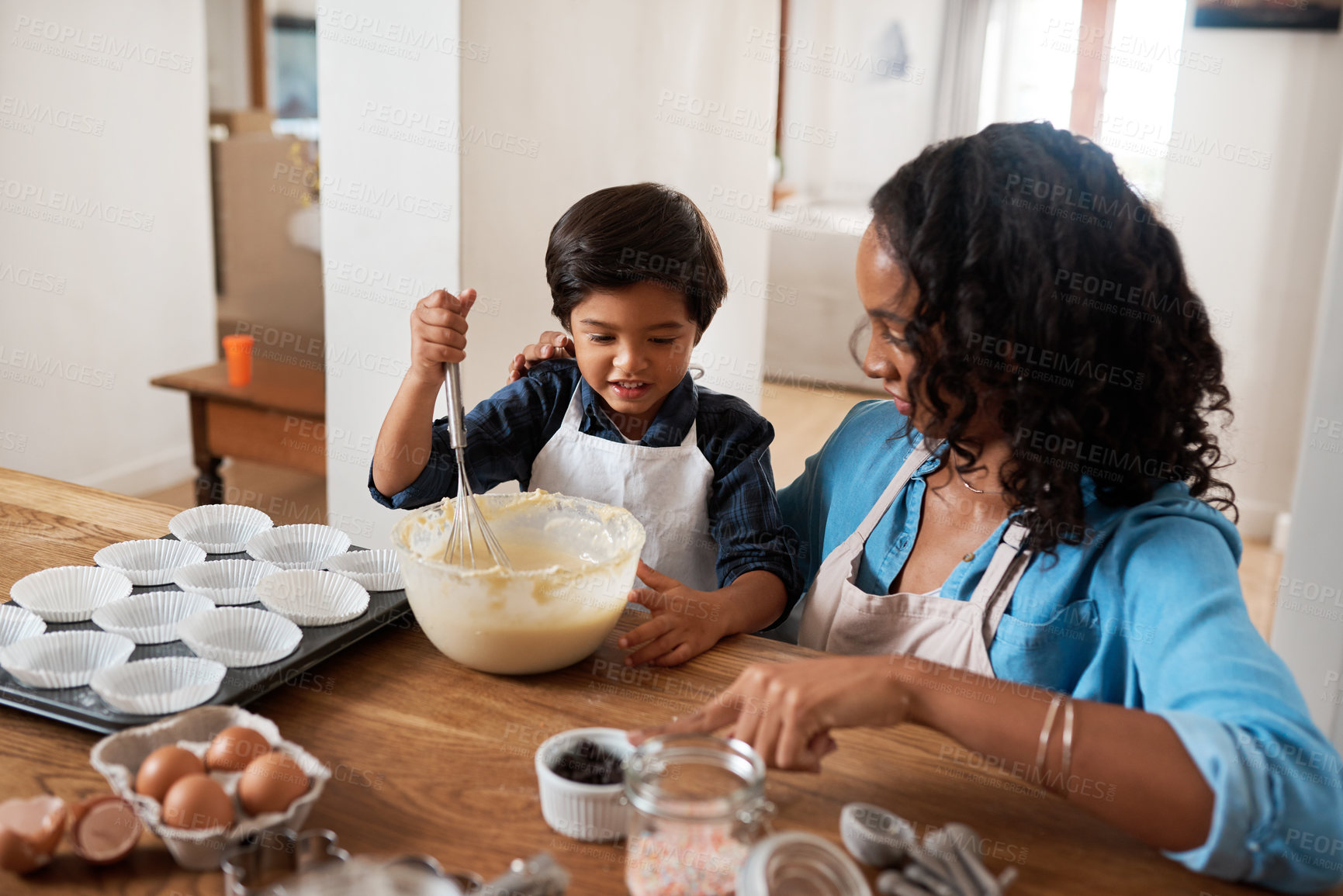 Buy stock photo Shot of a woman baking at home with her young son
