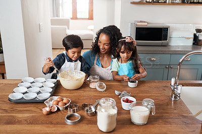 Buy stock photo Shot of a young woman baking with her two children