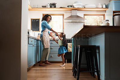 Buy stock photo Happy, mother with child dancing in kitchen and at their home. Family with love, entertainment or comic and laughing  female parent with daughter have fun together holding hands at their house