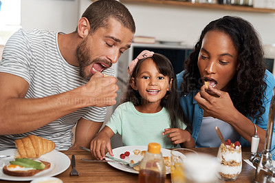 Buy stock photo Shot of a family of four enjoying breakfast together at home