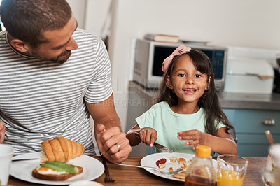 Buy stock photo Cropped shot of a man and his adorable daughter having breakfast at home