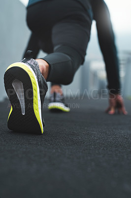 Buy stock photo Closeup shot of a sporty man in starting position while exercising outdoors