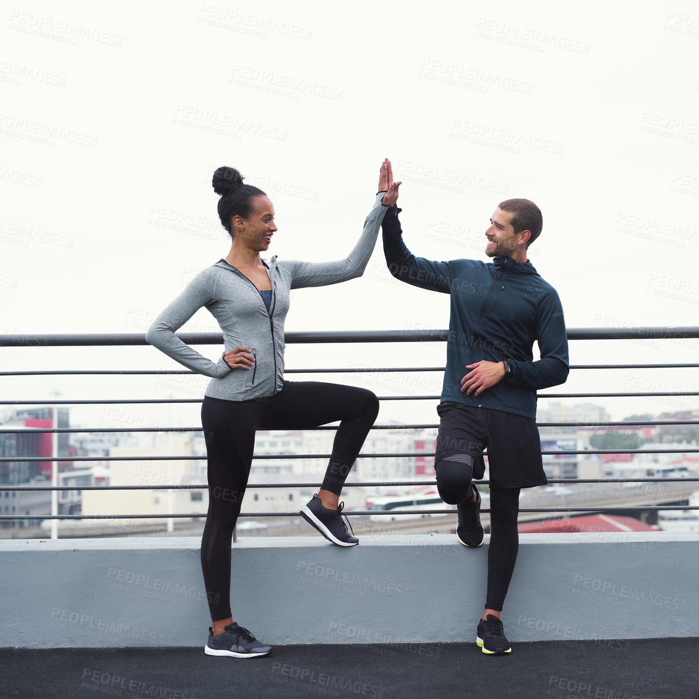 Buy stock photo Personal trainer, high five and fitness with exercise, outdoor and break with motivation, support or smile for goals. Man, woman and workout together for success, muscle or happy for teamwork in city