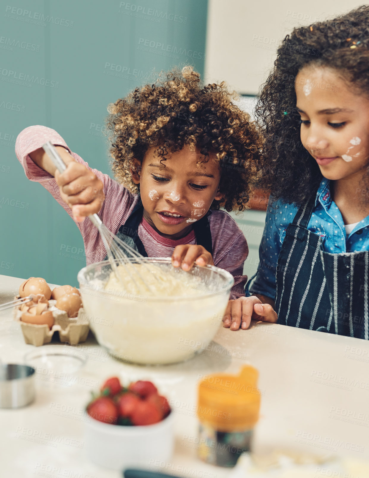 Buy stock photo Cropped shot of a young boy and girl baking in the kitchen at home