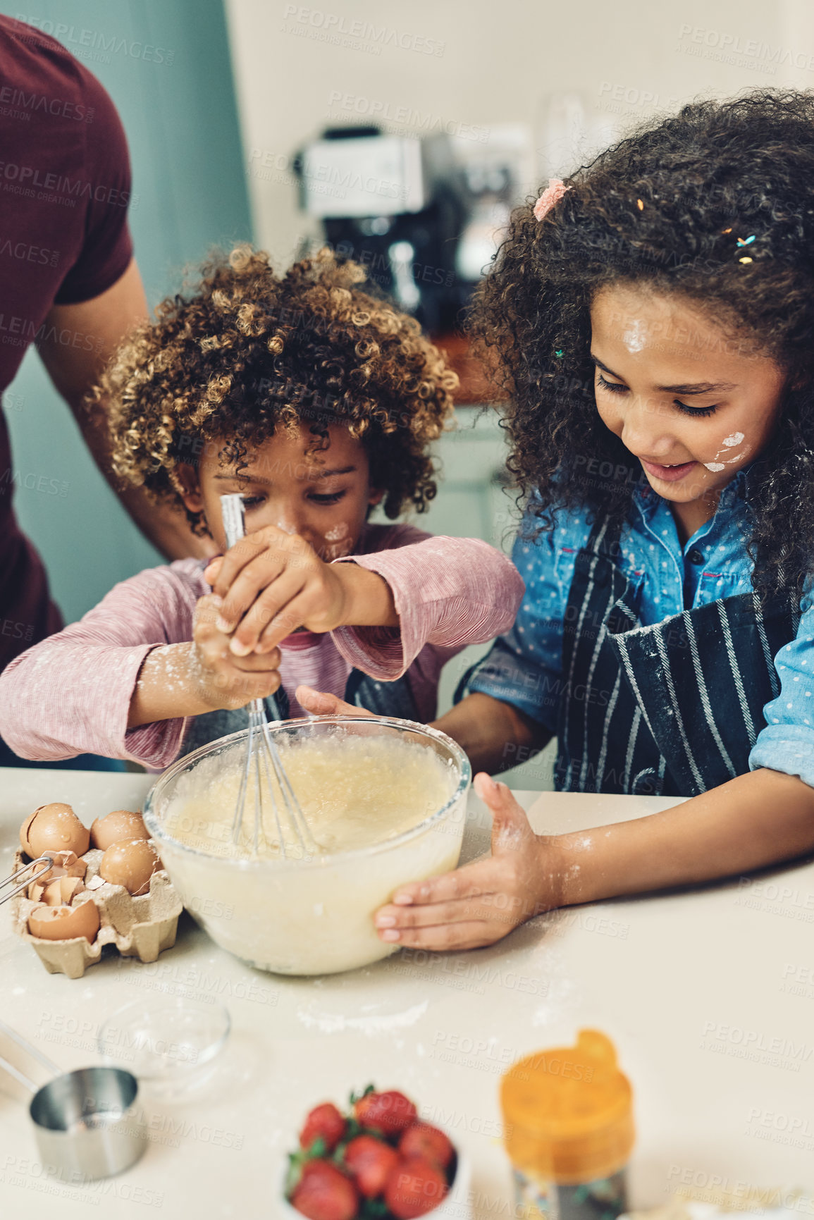 Buy stock photo Cropped shot of a young boy and girl baking in the kitchen at home