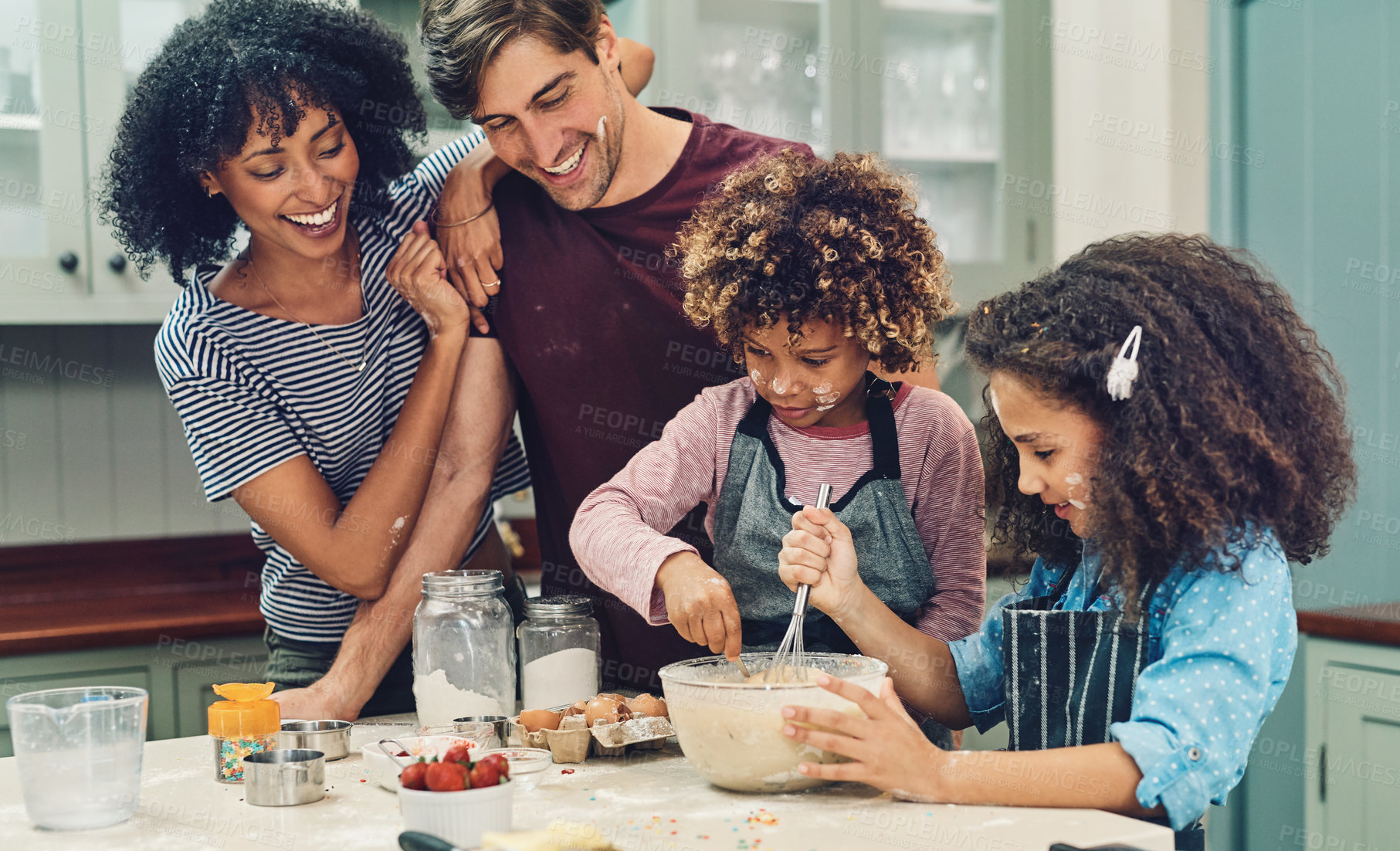 Buy stock photo Cropped shot of a young couple baking at home with their two children