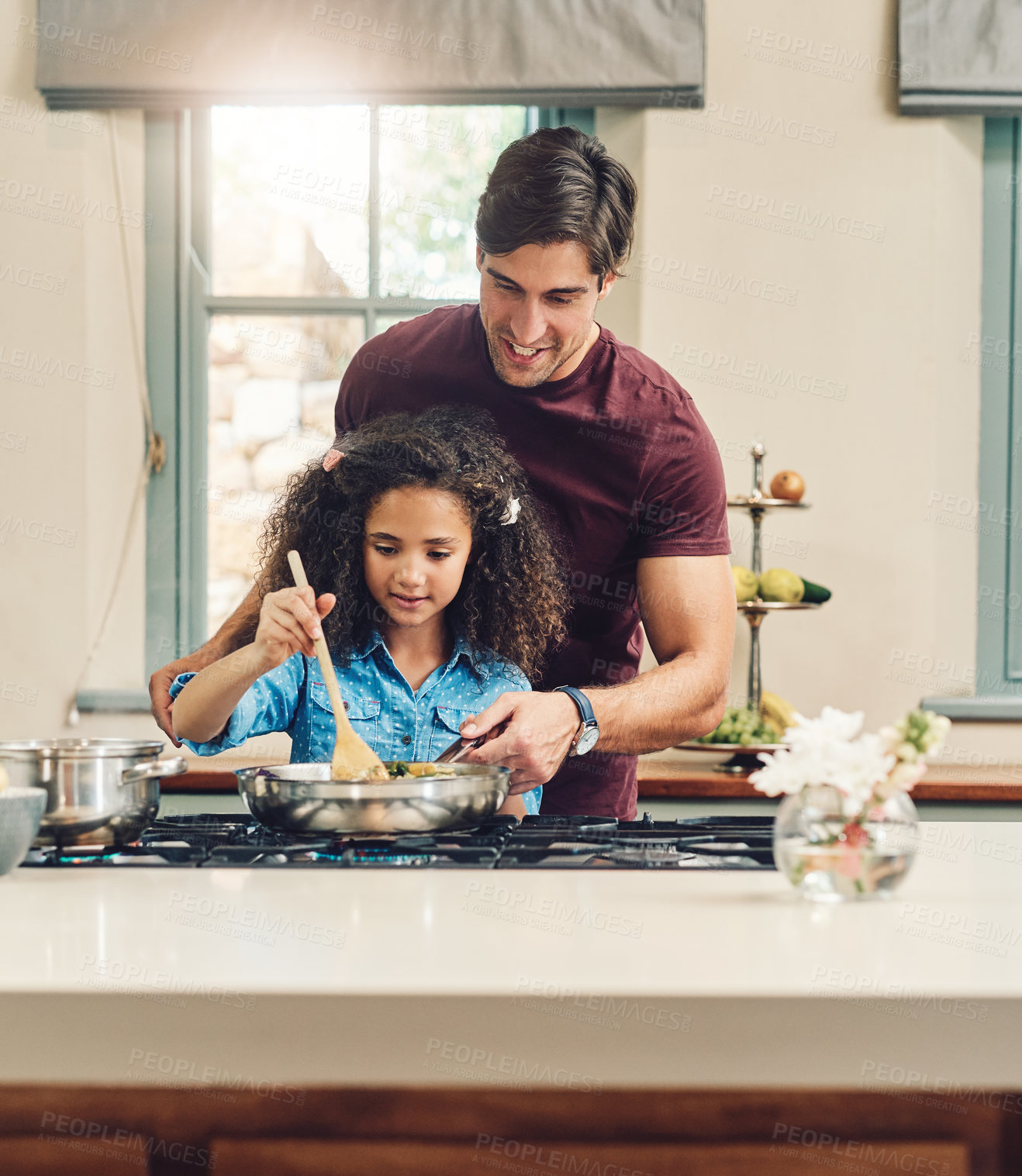Buy stock photo Shot of a young girl cooking at home with the help of her father