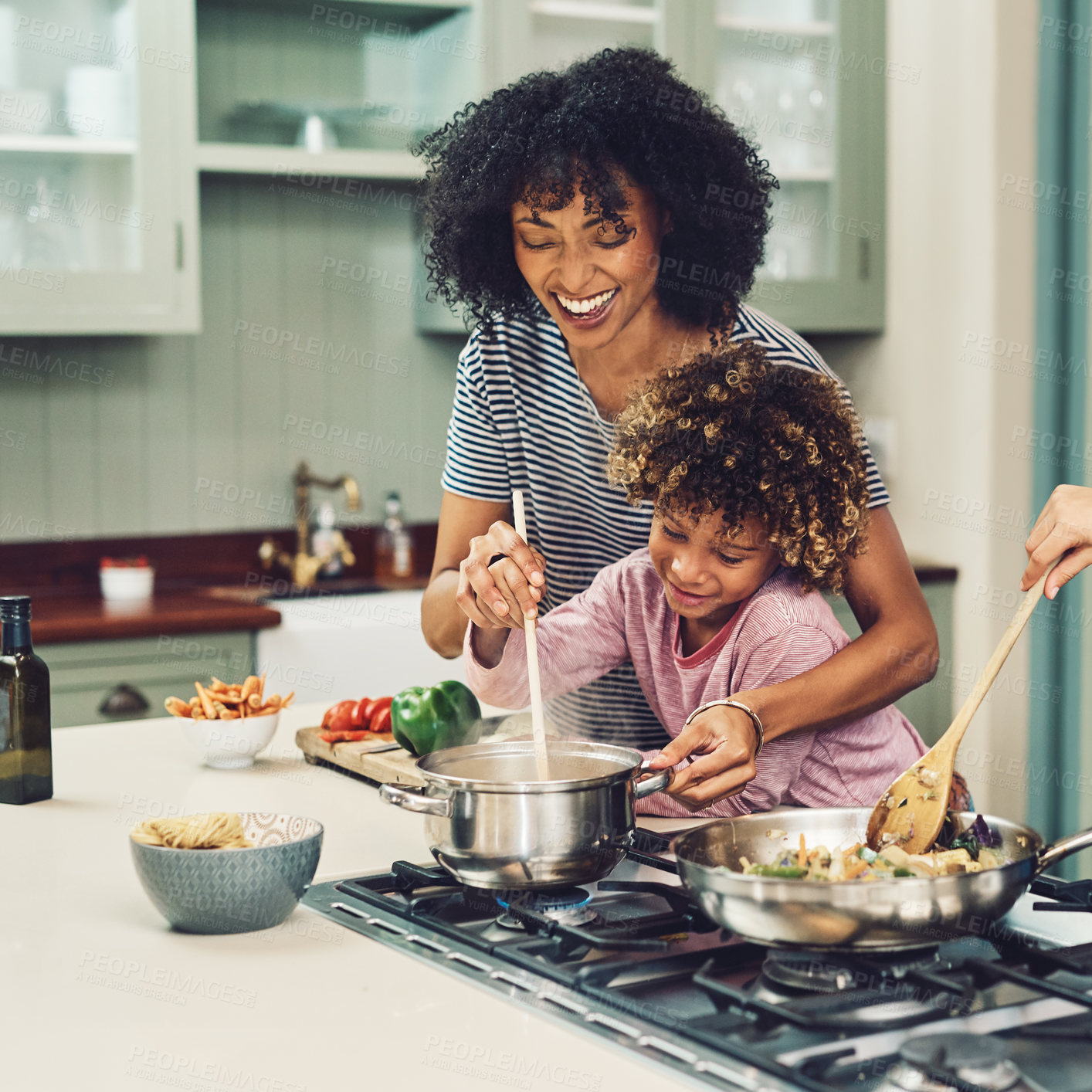 Buy stock photo Cropped shot of a young boy cooking with his mother in the kitchen at home