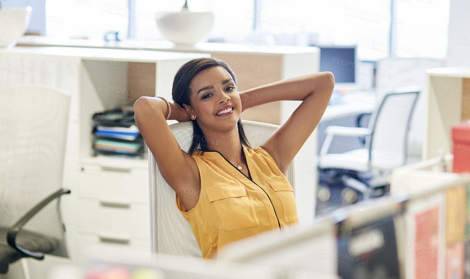 Buy stock photo Cropped portrait of an attractive young businesswoman leaning back in her chair with her hands behind her head in the office