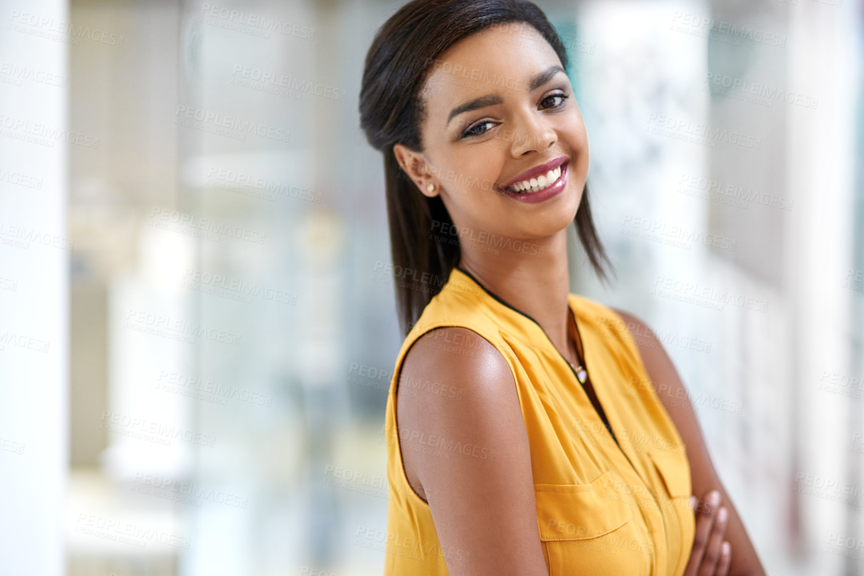 Buy stock photo Cropped portrait of an attractive young businesswoman standing with her arms crossed in the office