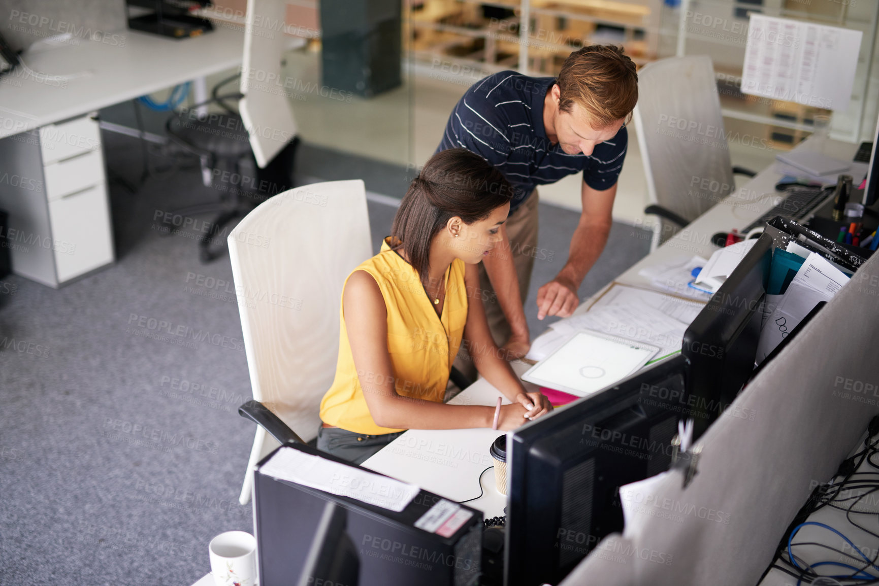 Buy stock photo Cropped shot of two business colleagues working together in their office