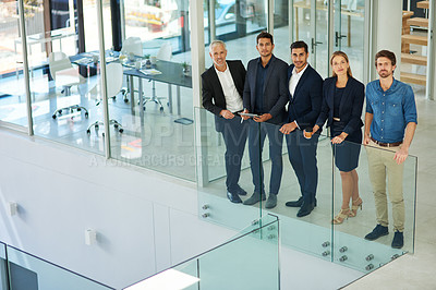 Buy stock photo Full length shot of a diverse group of businesspeople standing together in a modern office during the day