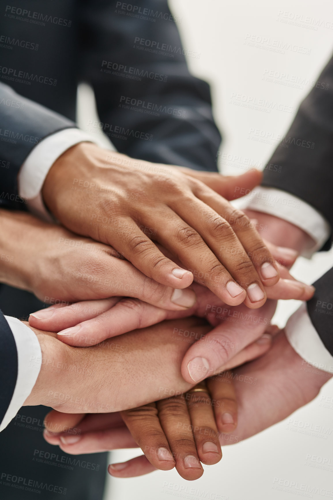 Buy stock photo Closeup shot of a group of unrecognizable businesspeople standing in a huddle with their hands stacked together