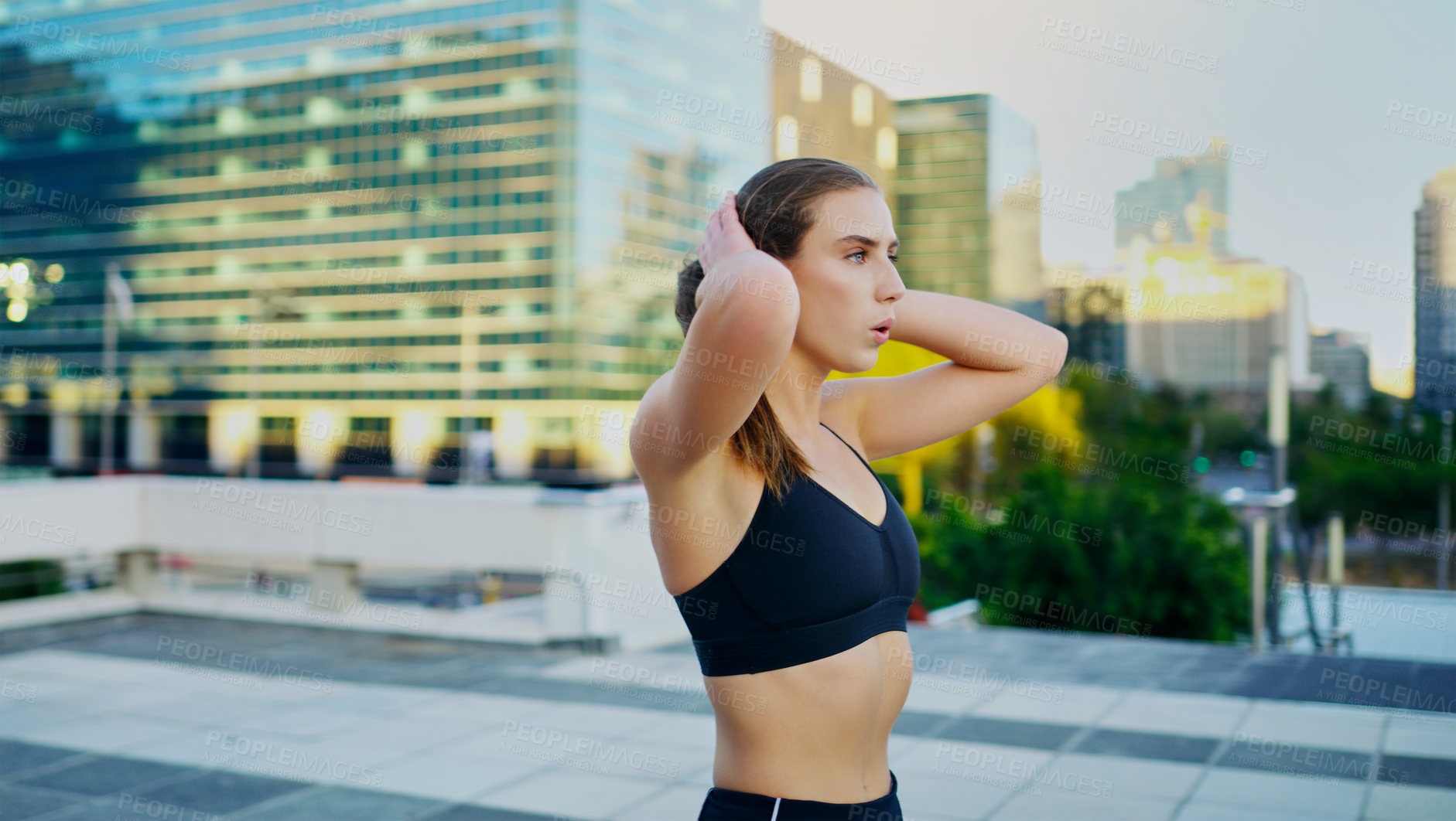 Buy stock photo Shot of a young woman taking a break from her workout in the city