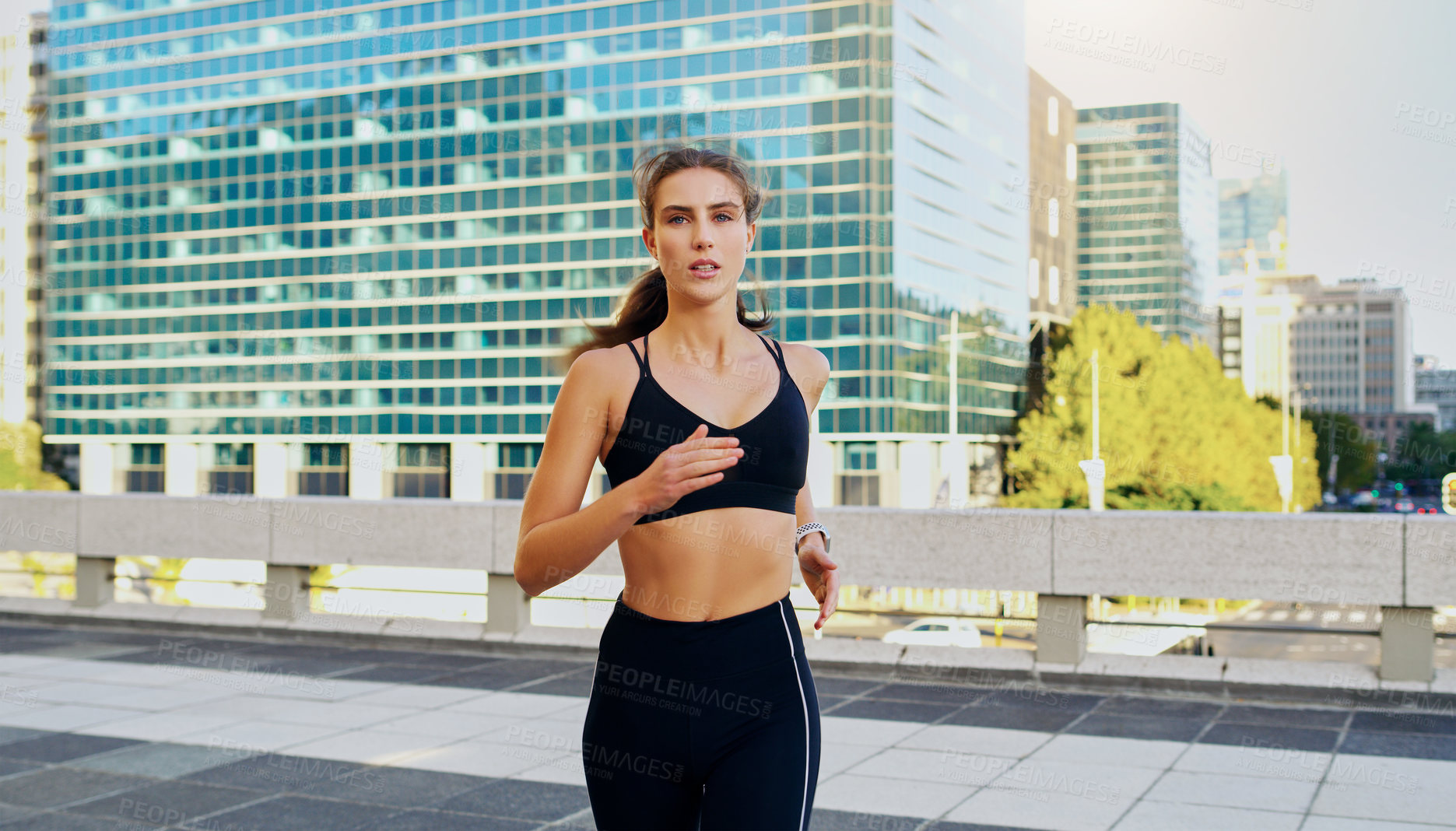 Buy stock photo Shot of a young woman going for a run in the city