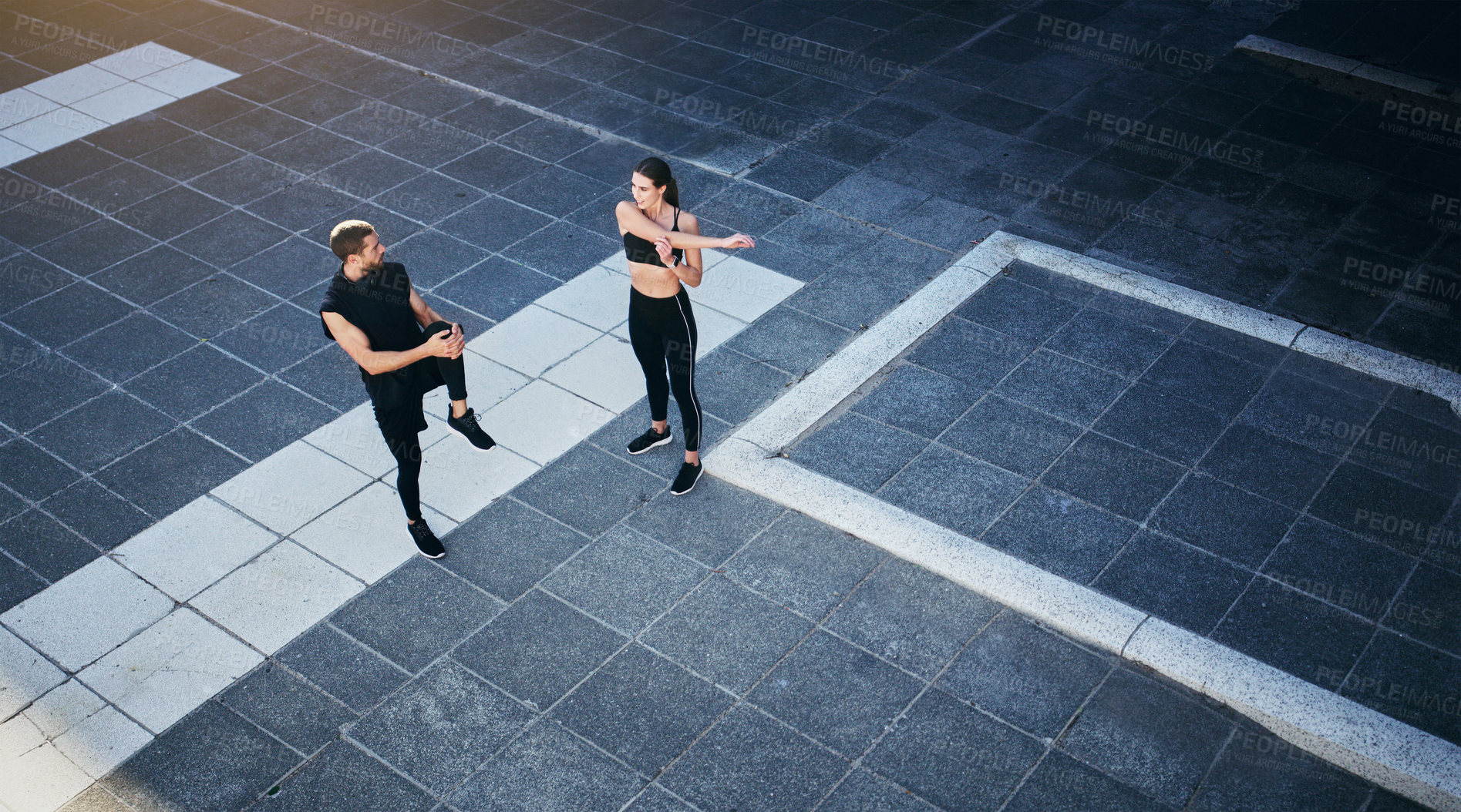 Buy stock photo Fitness, stretching or couple in city ready to start workout, training or outdoor exercise in London. Aerial, runners or sports man with woman in running warm up for energy, wellness or challenge