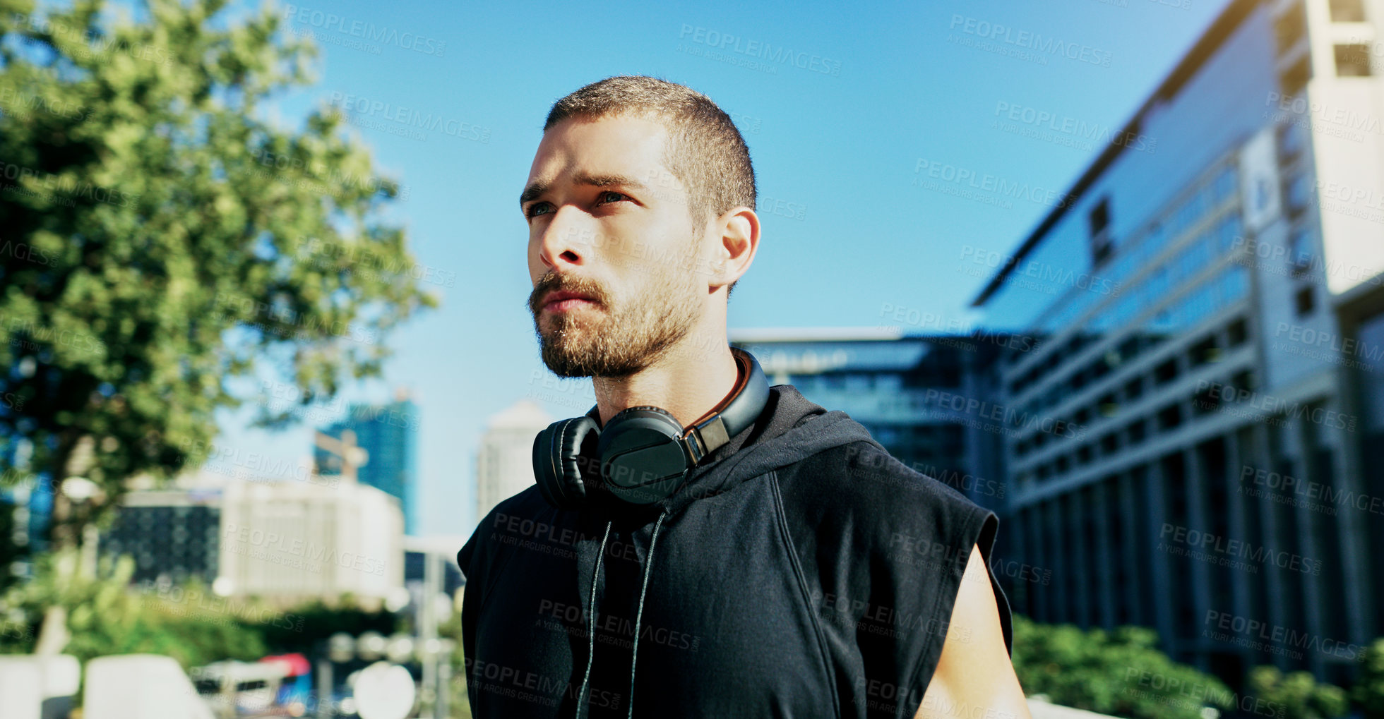 Buy stock photo Shot of a young man going for a workout in the city