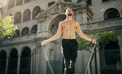 Buy stock photo Shirtless, man and skipping on rope in city for fitness, exercise and training, speed and endurance for competition. Athlete, active and jump with energy, practice and cardio from workout as runner