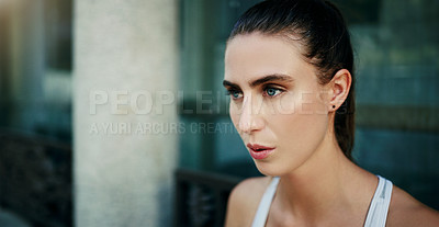 Buy stock photo Shot of a young woman going for a workout in the city