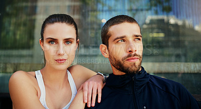 Buy stock photo Shot of a young couple going for a workout together in the city
