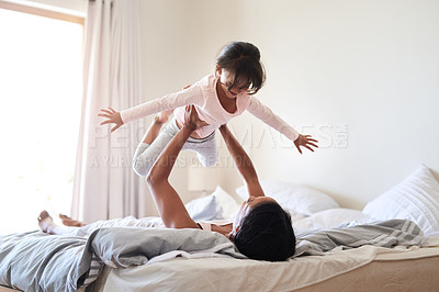 Buy stock photo Shot of an adorable little girl playing with her mother in bed at home