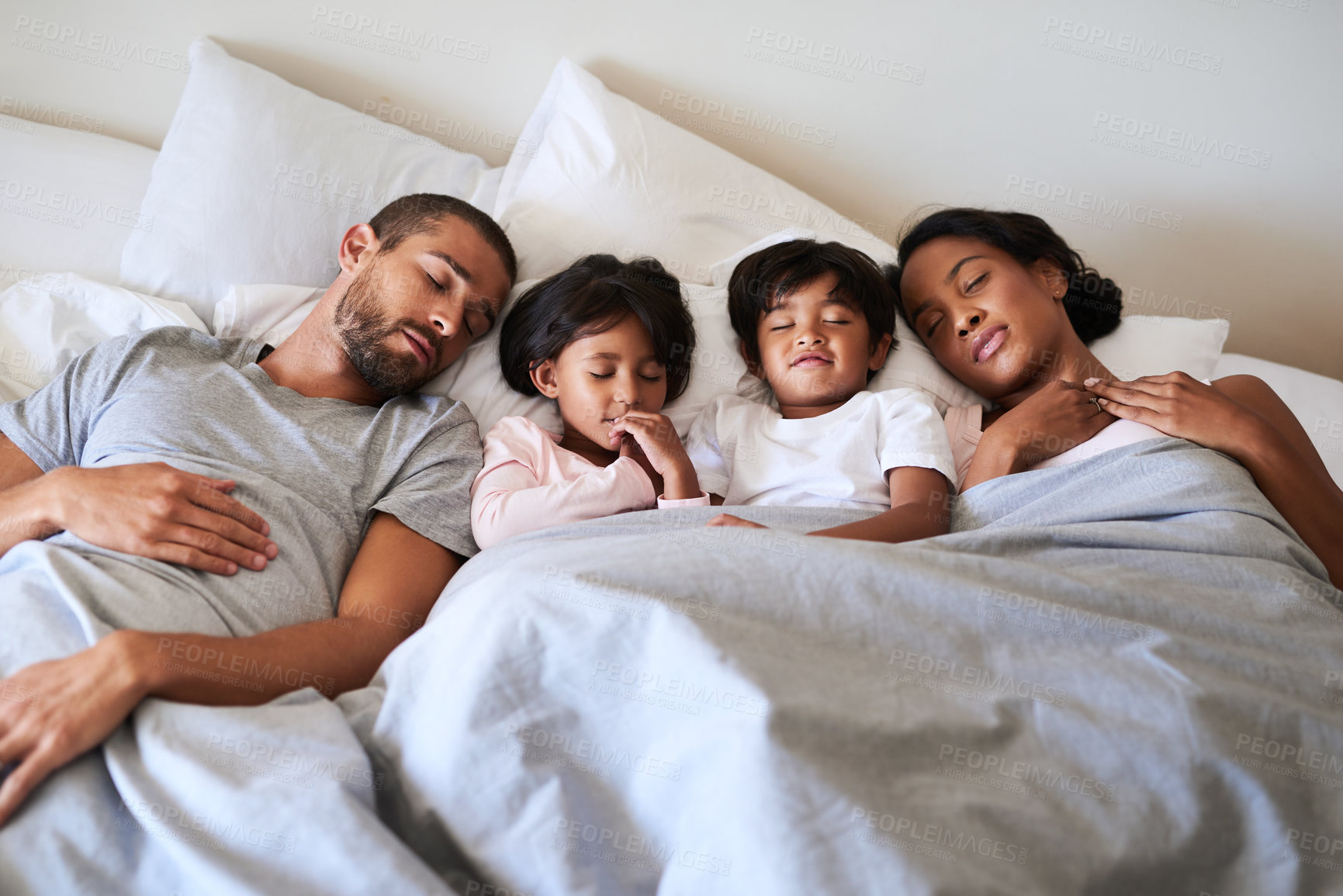 Buy stock photo Family, sleeping and tired in bed for bonding, relax and support together with mother, father and kids. Parents, fatigue and children as people in home for exhaustion, relationship and nap on weekend