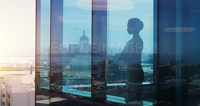 Buy stock photo Shot of a businesswoman looking thoughtful while looking out a window