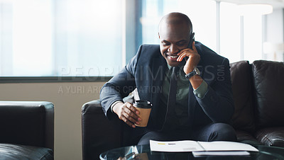 Buy stock photo Shot of a businessman talking on his cellphone while sitting in a modern office