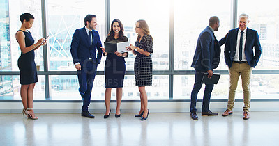 Buy stock photo Shot of a group of businesspeople standing in a modern office
