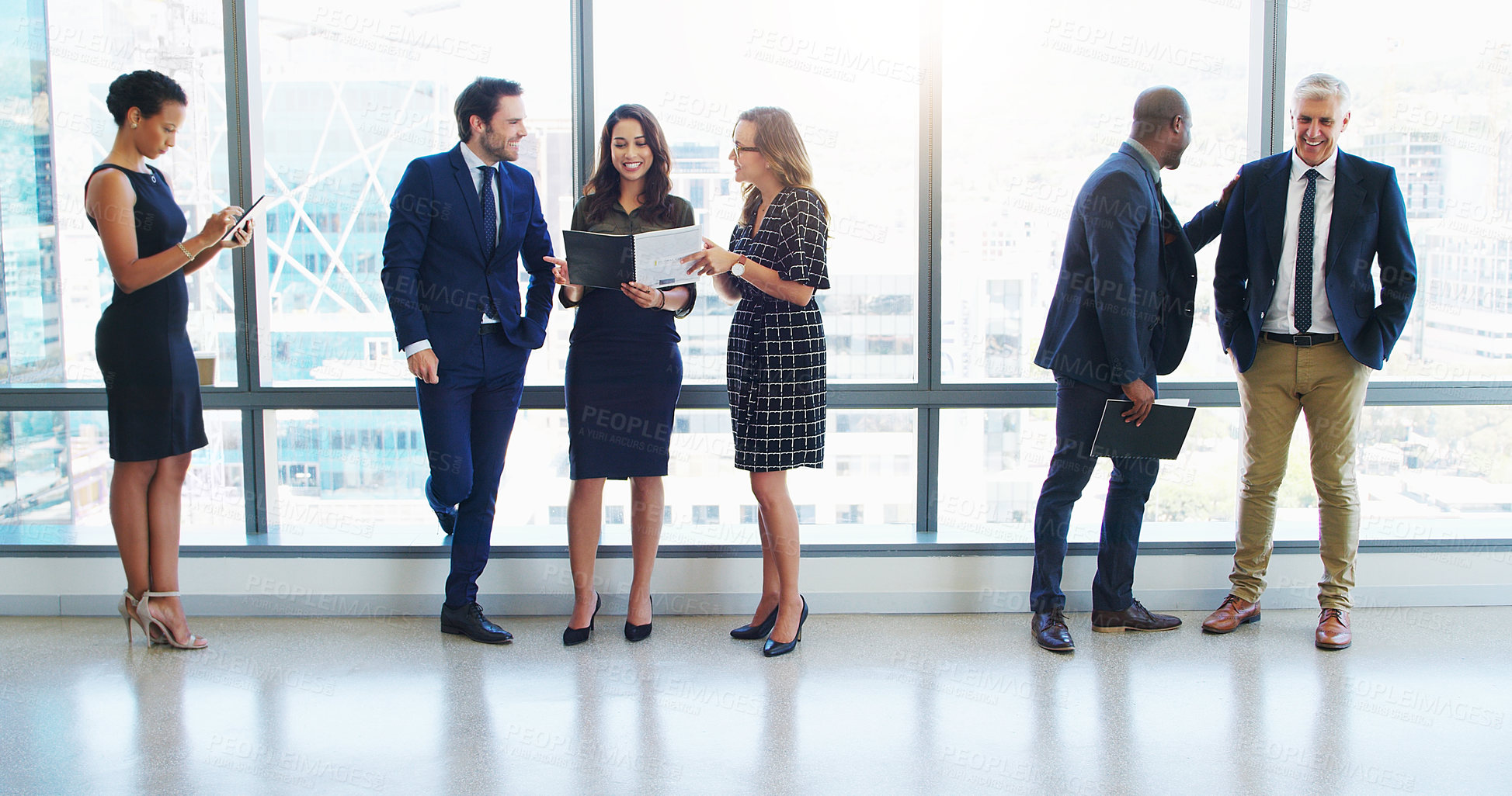 Buy stock photo Shot of a group of businesspeople standing in a modern office