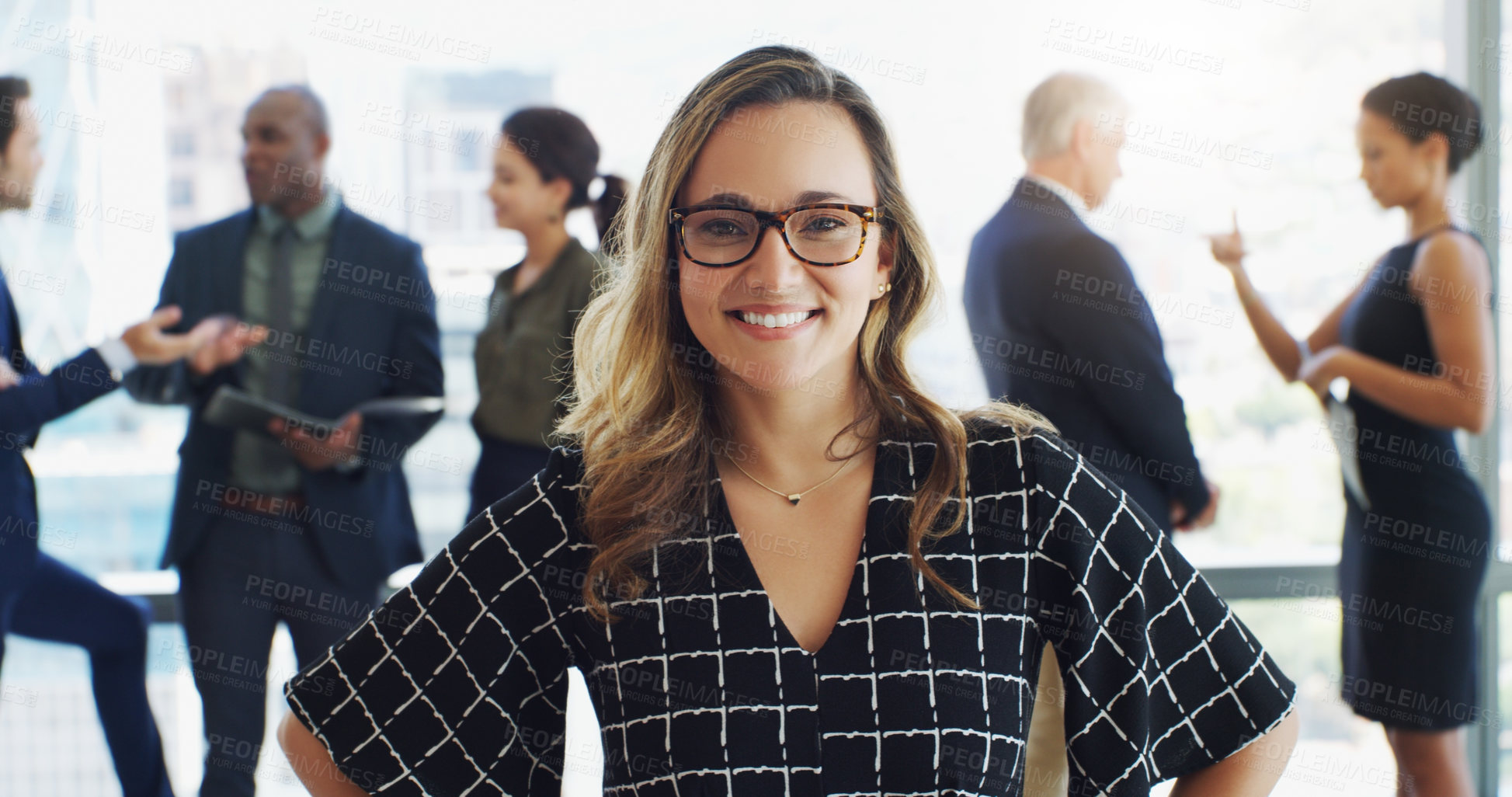 Buy stock photo Shot of an attractive businesswoman smiling at the camera while colleagues are blurred in background