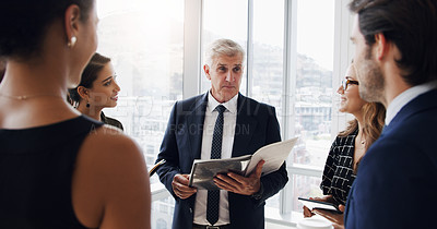 Buy stock photo Shot of a businessman having a meeting with his coworkers