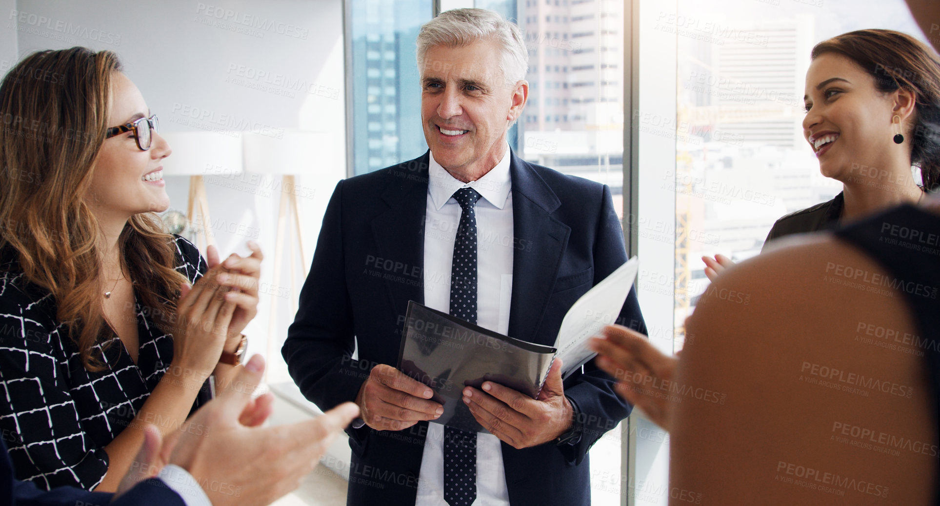 Buy stock photo Shot of a businessman having a meeting with his coworkers