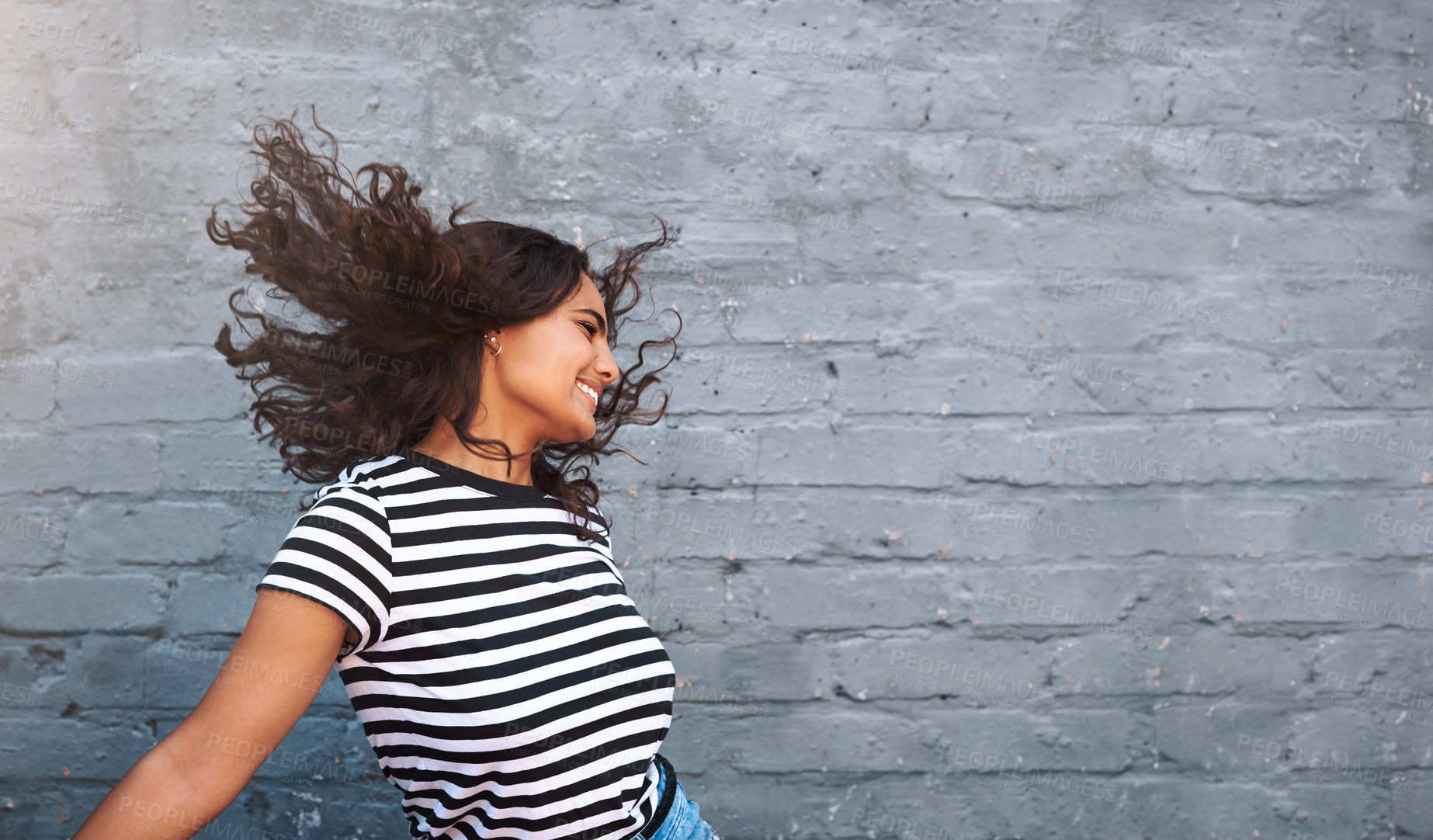 Buy stock photo Brick, wall and dance of girl, hair and outdoor for freedom, smile and break in weekend for fun. Dancer, person and happiness for holiday, summer and goofy in streetwear, tshirt and clothes in USA