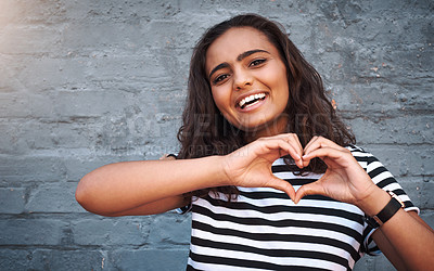 Buy stock photo Brick, wall and heart sign for girl, smile and hands for gesture, outdoor and break for weekend. Proud, excited and student on holiday, morning and happiness on face, model and city of New York