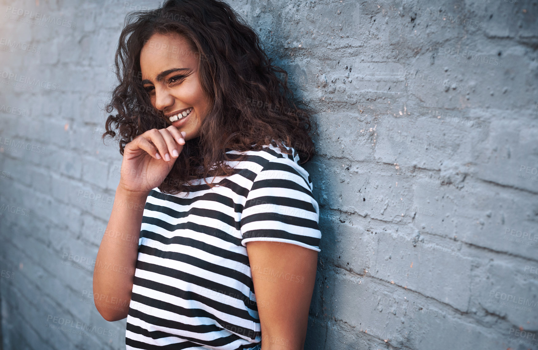 Buy stock photo Woman, laugh and happy on wall background with smile for happiness with gen z in city or town. Student, outdoor and  weekend or vacation at holiday house with trendy or cool fashion with positive