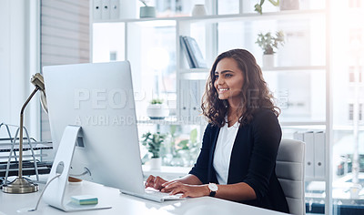 Buy stock photo Shot of a young businesswoman working on a computer in an office