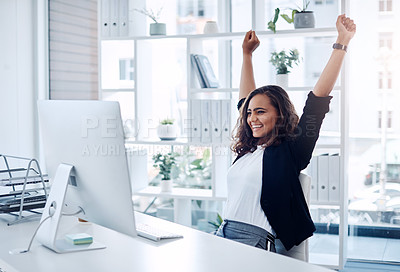 Buy stock photo Shot of a young businesswoman cheering while working in an office