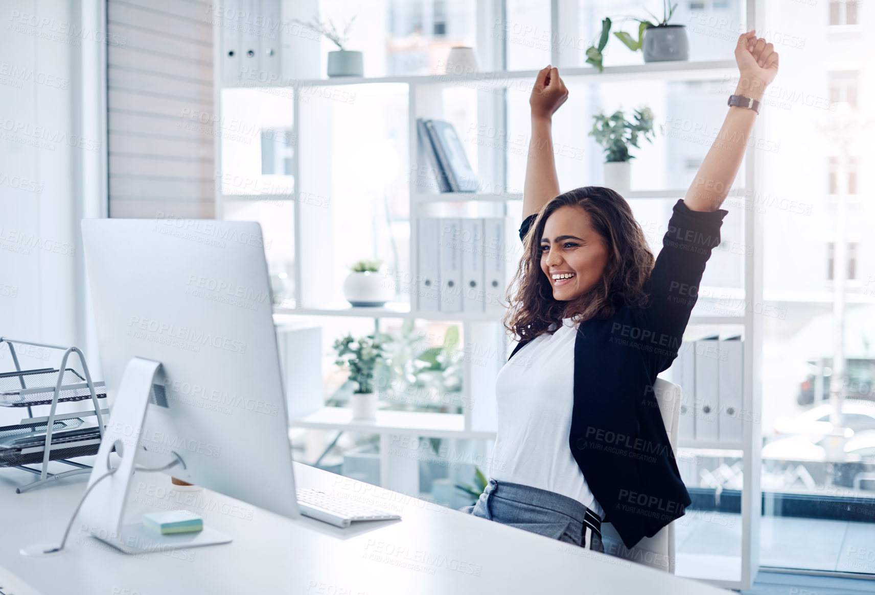 Buy stock photo Shot of a young businesswoman cheering while working in an office