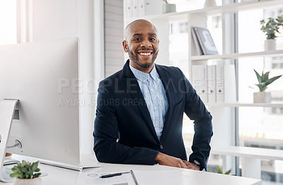 Buy stock photo Cropped shot of a handsome young businessman sitting at his desk