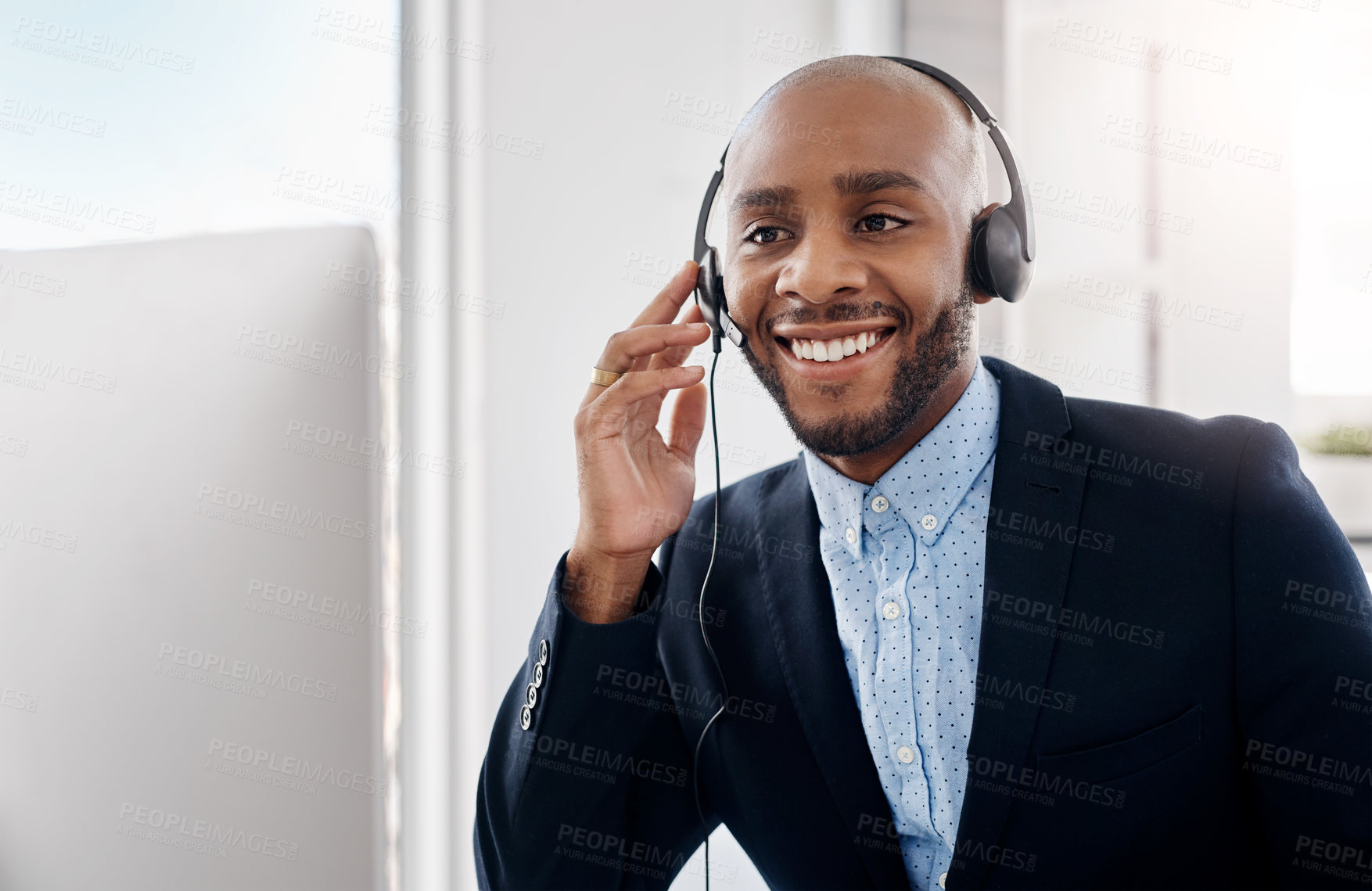 Buy stock photo Cropped shot of a call centre agent sitting at his desk