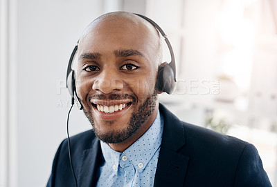 Buy stock photo Cropped shot of a call centre agent sitting at his desk