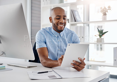 Buy stock photo Cropped shot of a young businessman using a digital tablet at his desk