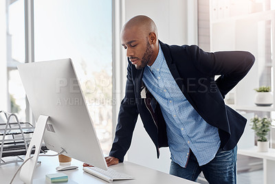 Buy stock photo Cropped shot of a businessman suffering from back pain at the office