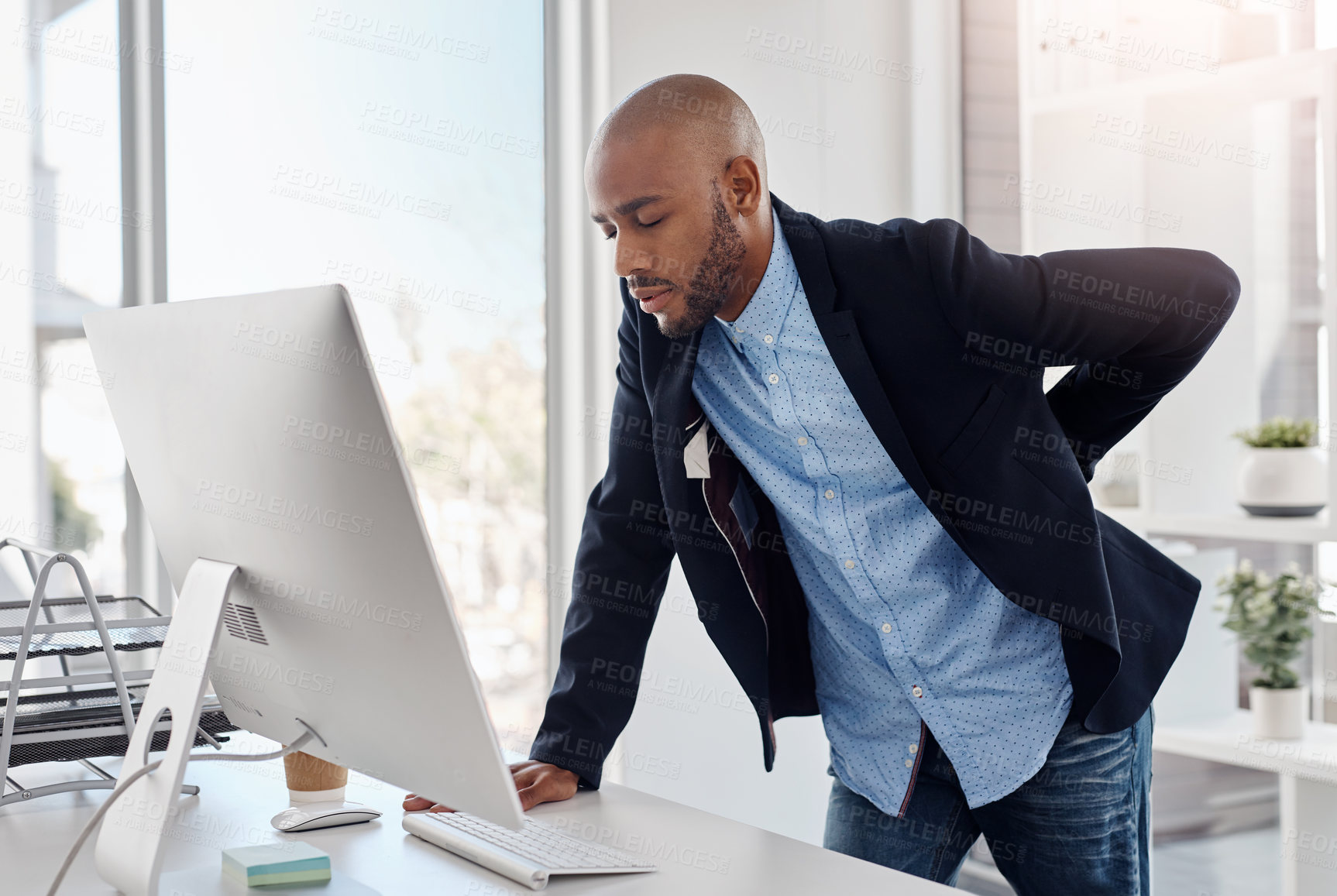 Buy stock photo Cropped shot of a businessman suffering from back pain at the office