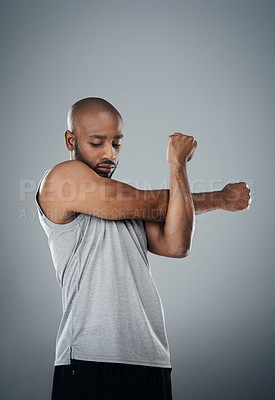 Buy stock photo Stretching, black man and confident in studio for fitness, workout and exercise on gray background. Male person, serious and trainer with sportswear with training for health, wellbeing and self care