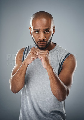 Buy stock photo Black man, portrait and fists for martial arts in studio, fighter and battle or warrior on gray background. Male person, punch exercise and combat training, sports challenge and boxer for workout